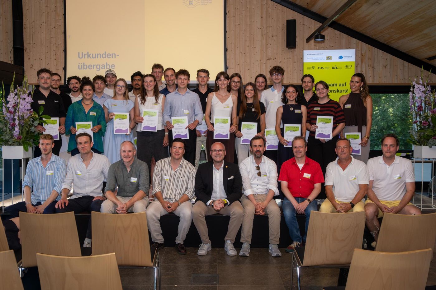 Gruppenfoto der Absolventinnen und Absolventen mit Urkunden